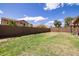 Well-kept backyard featuring a grassy area, a block wall, and mature trees for shade at 4529 E Thistle Landing Dr, Phoenix, AZ 85044