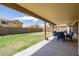 Spacious backyard with green grass, covered patio, and block wall providing privacy at 4529 E Thistle Landing Dr, Phoenix, AZ 85044