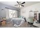 Comfortable bedroom with a desk, carpet, ceiling fan, chair and window with curtains at 4529 E Thistle Landing Dr, Phoenix, AZ 85044