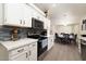 Bright kitchen with white cabinets, stainless steel appliances, and dining area at 4529 E Thistle Landing Dr, Phoenix, AZ 85044