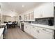 Well-lit kitchen with stainless appliances, white cabinets and dining table area at 4529 E Thistle Landing Dr, Phoenix, AZ 85044