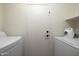 Bright laundry room featuring white appliances and a convenient door to the exterior at 4529 E Thistle Landing Dr, Phoenix, AZ 85044