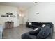 Cozy living room with view of entryway, cabinets, comfortable dark blue sofa, and light gray wood-look floors at 4529 E Thistle Landing Dr, Phoenix, AZ 85044