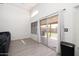 Bright living room with sliding glass doors, neutral gray paint, views of the landscaped backyard and patio at 4529 E Thistle Landing Dr, Phoenix, AZ 85044