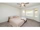 Relaxing main bedroom with ceiling fan, tan carpet, large windows, neutral paint and comfortable bed at 4529 E Thistle Landing Dr, Phoenix, AZ 85044
