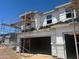 Construction view of a two-story home's exterior showing window and garage door installations at 5820 E Covey Ln, Phoenix, AZ 85054