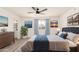 Comfortable bedroom with a tufted headboard, light-filled window, and neutral color palette; artwork on walls at 6351 W Mountain View Rd, Glendale, AZ 85302