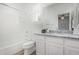 Bathroom with white vanity, granite countertops, and tiled shower at 669 E Scenic St, Apache Junction, AZ 85119