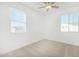 Bright bedroom with a ceiling fan and natural light through windows at 669 E Scenic St, Apache Junction, AZ 85119