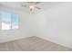 Bright bedroom with a ceiling fan and natural light through windows at 669 E Scenic St, Apache Junction, AZ 85119