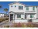 Stylish townhouse featuring a gray brick facade, white stucco, and a well-maintained front yard with desert landscaping at 669 E Scenic St, Apache Junction, AZ 85119