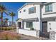 Inviting two-story townhouse featuring desert landscaping, gray brick accents, and a charming white stucco exterior at 669 E Scenic St, Apache Junction, AZ 85119