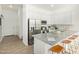 Bright, open kitchen featuring a large island with seating, stainless steel appliances, and stylish pendant lighting at 669 E Scenic St, Apache Junction, AZ 85119