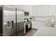 Modern kitchen with stainless steel appliances, granite countertops, and white cabinetry at 669 E Scenic St, Apache Junction, AZ 85119