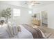 Airy main bedroom with dual windows, neutral decor, and a view to the adjoining bathroom at 669 E Scenic St, Apache Junction, AZ 85119