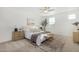 Bright main bedroom featuring a ceiling fan, decorative rug, accent furniture, and neutral color palette at 669 E Scenic St, Apache Junction, AZ 85119