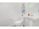Stylish powder room featuring a pedestal sink, decorative mirror, and modern fixtures at 669 E Scenic St, Apache Junction, AZ 85119
