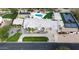 Expansive property featuring a pool, sports court, lush landscaping, and modern solar panels at 6718 E Caron Dr, Paradise Valley, AZ 85253