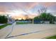 Expansive backyard offering a volleyball court, sandy lounge area, trampoline, and convenient access to the home at 6718 E Caron Dr, Paradise Valley, AZ 85253
