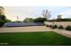 Backyard featuring solar panels, well-maintained lawn, landscaping, and a private wall for added seclusion at 6718 E Caron Dr, Paradise Valley, AZ 85253