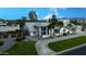 Stunning home featuring lush landscaping, a circular driveway, and a stylish, light-colored exterior at 6718 E Caron Dr, Paradise Valley, AZ 85253