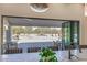 Indoor outdoor living with countertop seating looking out through folding doors to the backyard pool and patio at 6718 E Caron Dr, Paradise Valley, AZ 85253