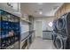 A modern laundry room with stacked washer/dryer, sleek countertops, and ample storage at 6718 E Caron Dr, Paradise Valley, AZ 85253