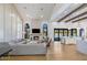Open-concept living room with fireplace, vaulted ceilings, wood beams, hardwood floors, and seamless indoor/outdoor living at 6718 E Caron Dr, Paradise Valley, AZ 85253