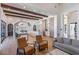 Spacious open floor plan featuring wood beams, hardwood floors, and seamless flow to the adjacent kitchen at 6718 E Caron Dr, Paradise Valley, AZ 85253