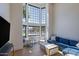 Bright living room with large windows, comfortable seating, and modern finishes at 6718 E Caron Dr, Paradise Valley, AZ 85253