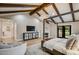 Spacious main bedroom with vaulted ceiling, dark wood beams, and a cozy fireplace at 6718 E Caron Dr, Paradise Valley, AZ 85253