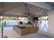 Inviting outdoor living space with a fireplace, grill, TV, comfortable seating, and access to the sports court at 6718 E Caron Dr, Paradise Valley, AZ 85253