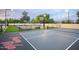 Multi-sport court with basketball, pickleball, and volleyball, lit for evening play with dusk sky above at 6718 E Caron Dr, Paradise Valley, AZ 85253