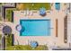 Aerial view of a community pool with lounge chairs and umbrellas at 8726 E Devonshire Ave Ave, Scottsdale, AZ 85251