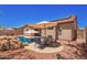 Beautiful backyard with patio seating, pool, and desert landscaping at 9259 W Caron Cir, Peoria, AZ 85345