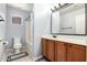 A well lit bathroom with a toilet, shower/tub combo, and sink with a light wood cabinet beneath at 9259 W Caron Cir, Peoria, AZ 85345