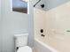 A bathroom with a white bathtub/shower combo and a white toilet with blue walls and tile floors at 9259 W Caron Cir, Peoria, AZ 85345