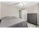 This bedroom features a ceiling fan, closet and a dresser with matching gray floors, and light gray walls at 9259 W Caron Cir, Peoria, AZ 85345
