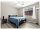 Clean bedroom featuring wood-look floors, ceiling fan, and large window with bright natural light at 9259 W Caron Cir, Peoria, AZ 85345