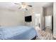 Spacious bedroom featuring ceiling fan, wood-look floors, and a convenient door to the bathroom at 9259 W Caron Cir, Peoria, AZ 85345