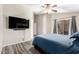 Comfortable bedroom featuring wood-look flooring, ceiling fan, and sliding glass door leading to backyard at 9259 W Caron Cir, Peoria, AZ 85345
