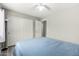 Comfortable bedroom features ceiling fan, neutral color palette, and door to large closet at 9259 W Caron Cir, Peoria, AZ 85345