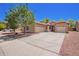 Home featuring a three car garage, desert landscaping and a driveway at 9259 W Caron Cir, Peoria, AZ 85345