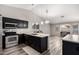 Modern kitchen featuring dark cabinets and stainless steel appliances at 9259 W Caron Cir, Peoria, AZ 85345