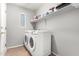 This laundry room has a new washer and dryer, modern paint and shelving at 9259 W Caron Cir, Peoria, AZ 85345