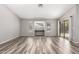 Spacious living room featuring modern wood look flooring and a view of backyard at 9259 W Caron Cir, Peoria, AZ 85345