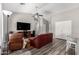 Cozy living room featuring a ceiling fan and wood-look flooring at 9259 W Caron Cir, Peoria, AZ 85345