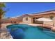 Sparkling pool and patio area with outdoor umbrellas, perfect for relaxing and enjoying the Arizona sun at 9259 W Caron Cir, Peoria, AZ 85345