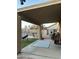 Inviting covered patio with a blue striped rug, offering a relaxing outdoor space overlooking the backyard at 9646 N 94Th Ave, Peoria, AZ 85345