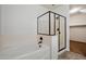 Bathroom with a bathtub, glass enclosed shower, and a clean, minimalist design at 12217 W Planada Ln, Sun City, AZ 85373